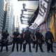 NYPD cops line up in Times Square Saturday night before clashing with protesters.